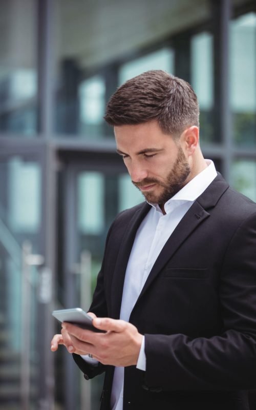 Businessman talking on mobile phone in office premises